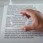 a close-up, high-angle studio photograph of a person's hand in a black shirt holding a round magnifying glass over a piece of white paper with black text, also visible is a transparent, grid-patterned mouse and another magnifying object, all dramatically lit on a light gray speckled surface