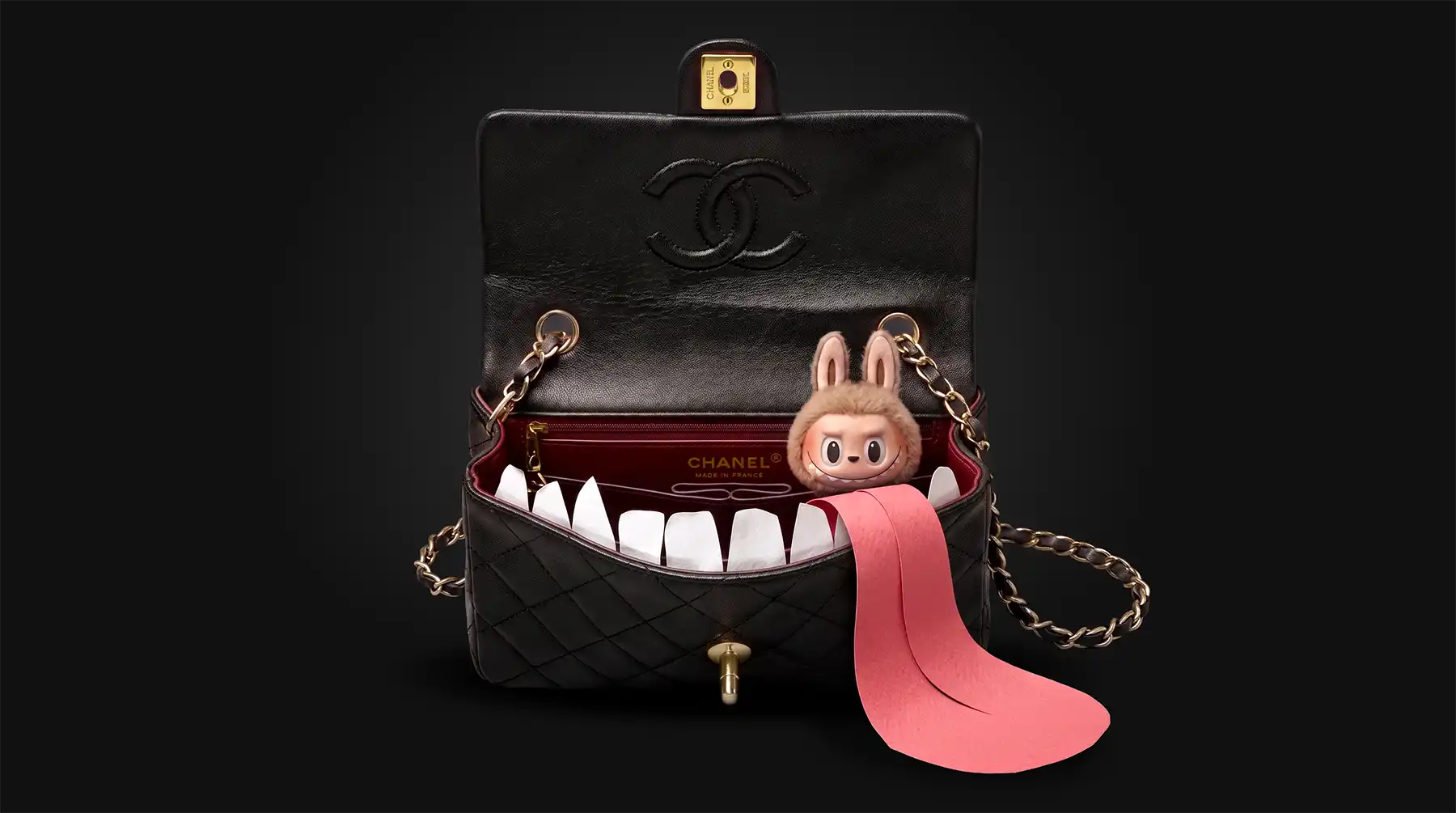 A creative, customized Chanel quilted leather bag is open, transformed into a playful monster. It eats a Labubu inside, paper fangs, and a long pink fabric tongue extending from the mouth, all set against a deep black background. This unique art piece combines luxury fashion and playful art.